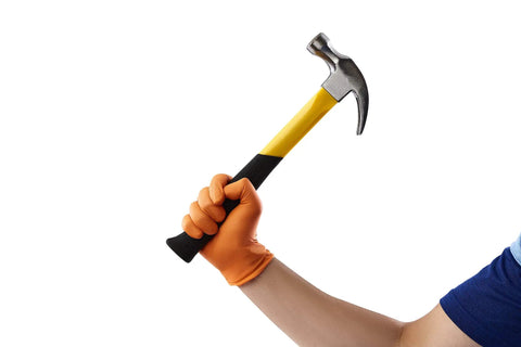 Hand wearing Hi Visibility Orange Nitrile Gloves 8 Mil Thick Large holding a hammer, demonstrating grip and durability