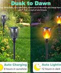 Solar Torch Lights With Flickering Flame Realistic Fire Effect For Outdoor Garden And Patio Easy Setup No Fuss Auto On Off Dust To Dawn Waterproof Landscape Decoration Solar Powered Security Torch Light Pack Of Four in garden setting