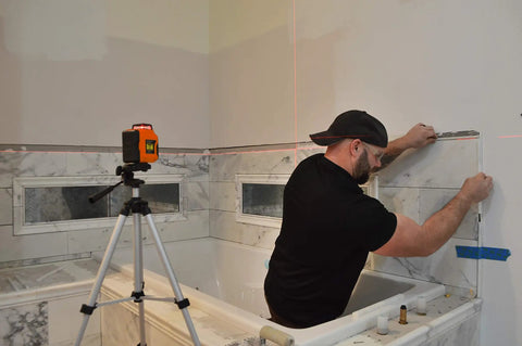 Self Leveling 360 Degree Line Laser With Horizontal And Vertical Beams 50 Ft Range High Precision About Three Sixteenths Inch On The Jobsite At Thirty Feet Four Point Two Inch Red Beam Locking Mechanism For Protection in use during bathroom tile installation