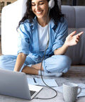Woman sitting on floor with headphones, using Premium 3.5 Mm Aux Extension Cable Three Pole Trs Headphone Extender Cord 3.3 Feet.