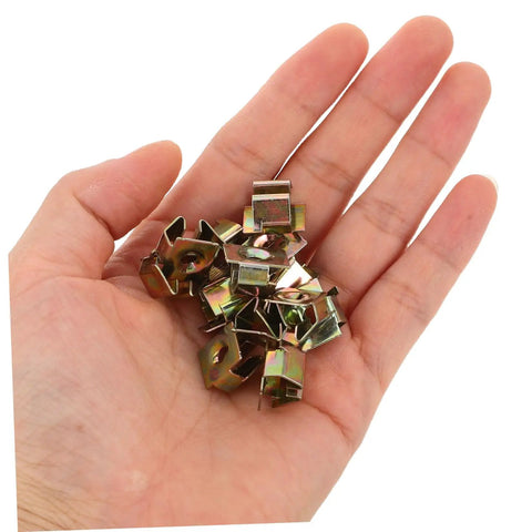 Heavy Duty Golden U Nut Fasteners For Truck And Rig 50 Pack in hand, metal clips for secure license plate mounting.