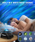 Couple sleeping under aurora sky from Northern Lights Aurora Projector 4 In 1 Night Light Ambient Galaxy Sky Projector With Bluetooth Speaker.