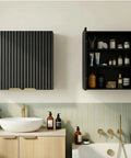 Slick Fluted Black Bathroom Wall Cabinet with Two Doors open, showing shelves with toiletries, wall mounted above a bathroom sink.