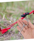 Hand holding a connector for 10 Pack Galvanized Tent Pole Connectors For Quick Setup And Lightweight Repair Camping Must Haves For Hiking And Outdoor Adventures Durable Easy To Use Keeps Shelters Secure next to tent ropes on the ground.