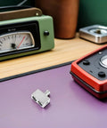 2 Pcs Premium Sonic Badass Car Audio Wire Reducer Dual Amp Input Adapter Aluminum Alloy on purple surface next to audio equipment