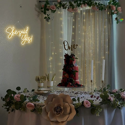 She Said Yes Neon Sign Warm White LED Wall Decor For Proposals And Engagements USB Powered above decorated table.