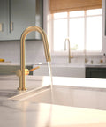 hansgrohe Talis N Pull Down Kitchen Faucet, Modern, Magnetic Hand Sprayer, 1-Handle, 1.75 GPM, Brushed Bronze, 72866141 pouring water from sink