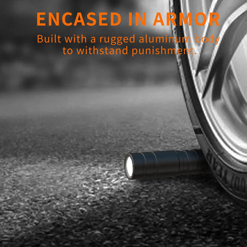 LED Pen Light With Zoomable Beam 270 Lumens Pocket Size Clip Flashlight under car wheel, showing durability