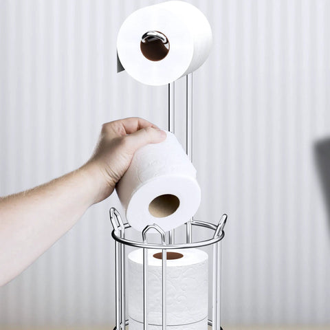 Hand placing roll on Toilet Paper Holder Stand And Tissue Roll Dispenser For Four Mega Rolls Freestanding Bathroom Storage Rack