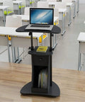 Straight Up Solid Rolling Laptop Cart in classroom with adjustable height, black MDF surface, storing books underneath.