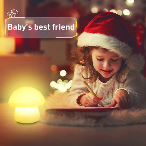 Child writing beside rechargeable mushroom night light with tap and remote control cordless multicolor LED nightlight dimmable silicone nursery lamp for breastfeeding and sleep portable baby bedroom light kid friendly.