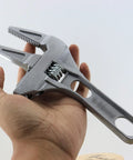 No Hassle Adjustable Short Handle Bath Wrench held in hand showing ergonomic design and wide jaw for bathroom fixtures.