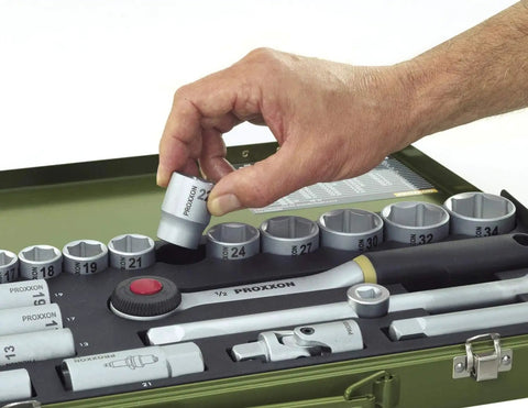 Hand holding socket from 36 Piece Socket Set with Quarter Inch Square Drive Includes 13mm Sockets Slotted Phillips Torx And Allen Bits