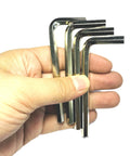 Four Piece One Quarter Inch Allen Wrench Set With Long Arm L Shaped Hex Keys held in hand on white background