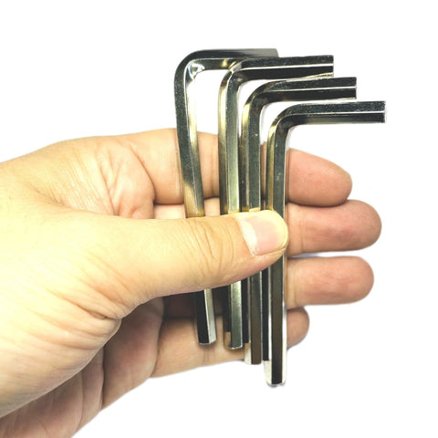Four Piece One Quarter Inch Allen Wrench Set With Long Arm L Shaped Hex Keys held in hand on white background