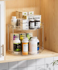 2 Tier Lazy Susan Turntable Organizer For Narrow Cabinets in a wooden shelf, holding supplements and medicine bottles.