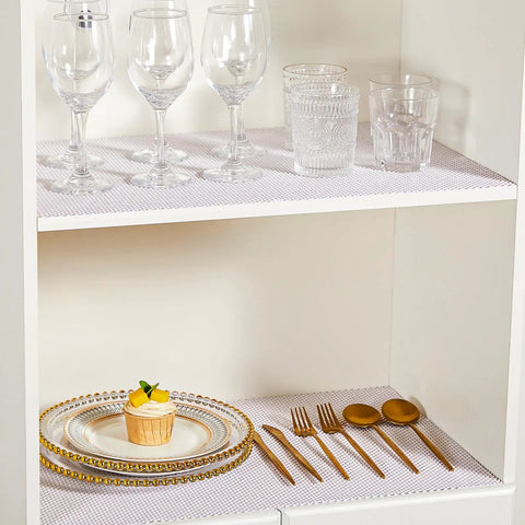 Top Shelf Nonslip Shelf Liner For Kitchen Cabinets And Drawers, White Non Adhesive Mat, on shelves with glassware and plates.