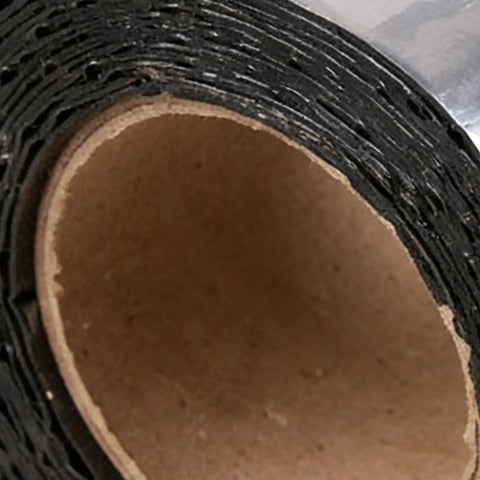 Close-up of Self Adhesive Asphalt Sealer Tape For Waterproof Crack Repair roll, showcasing the black tape and cardboard core.