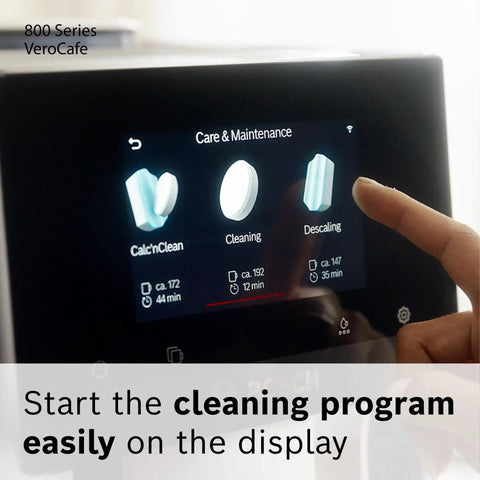 Finger selecting cleaning function on VeroCafe 800 Series espresso machine display featuring Calc'nClean, Cleaning, Descaling.