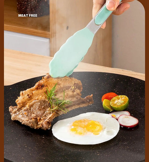 Thin 9.4 Inch Iron Grill Pan With Nonstick Coating For Stovetop Cooking, showing seared meat and egg with tongs on grill pan.