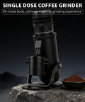 Heavy Duty Electric Burr Coffee Grinder With Sixty Fine Adjustments And 48 Millimeter Conical Steel Burrs For Dank Fresh Grinding And Smooth Barista Style Single Dose Pulls on a rocky surface with coffee grounds.