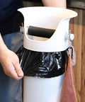Person attaching a black liner to the Heavy Duty White Coffee Knock Box And Espresso Dump Bin Featuring Shock Absorbent Base For Fast Grinder Cleanup Removable Liners Keep Your Bar Setup Looking Fly And Super Neat.