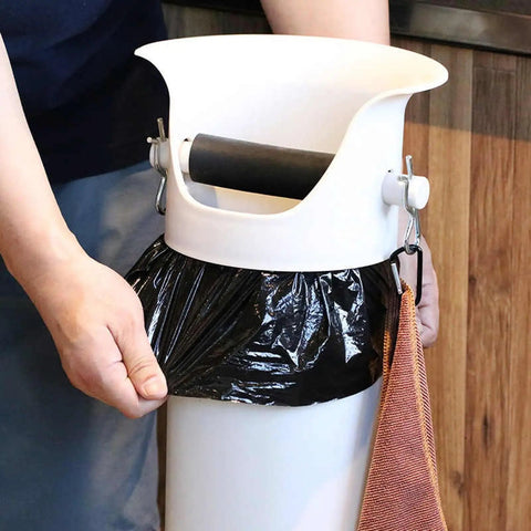 Person attaching a black liner to the Heavy Duty White Coffee Knock Box And Espresso Dump Bin Featuring Shock Absorbent Base For Fast Grinder Cleanup Removable Liners Keep Your Bar Setup Looking Fly And Super Neat.