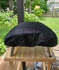 Heavy Duty 600D Pizza Oven Cover For Ooni Koda 16 Gas Oven on a table, showing outdoor weather-resistant protection.