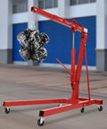 No Sweat Lifting Weights With This 2 Ton Folding Engine Hoist And Shop Crane lifting an engine with smooth rolling casters.