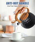 Hand pouring from Stovetop Tea Kettle 3.2 Quart Stainless Steel Whistling Teapot With Wood Pattern Handle into cup