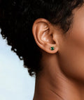 Snag Dope G23 Implant Grade Titanium Screw Back Earrings Hypoallergenic Nickel Free Jewelry For Sensitive Skin lightweight 5mm green zirconia studs worn on ear.