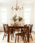 Dining room with Six Light Distressed White French Country Candle Chandelier With Cozy Vintage Vibe For Living Room Dining Room Bedroom 24 Inch Wide Rustic Ceiling Fixture over wooden table.