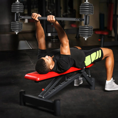 Man using Turn Your Dumbbells Into A Barbell With This Adjustable EZ Curl Bar Adapter in a gym on a red bench for bench press