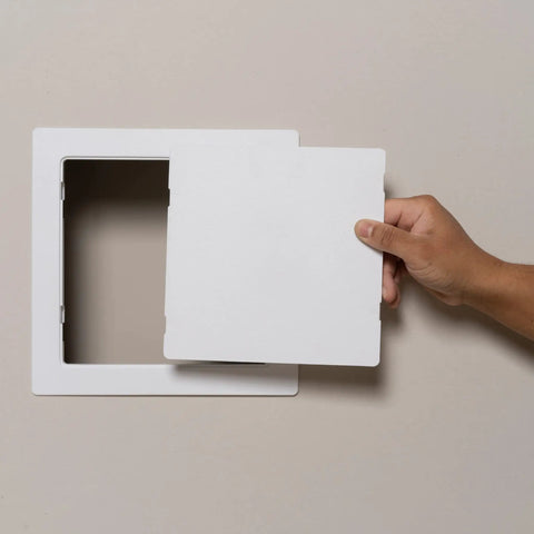 Eight By Eight Inch White Access Panel For Plumbing And Electrical Cables shown being installed into drywall.