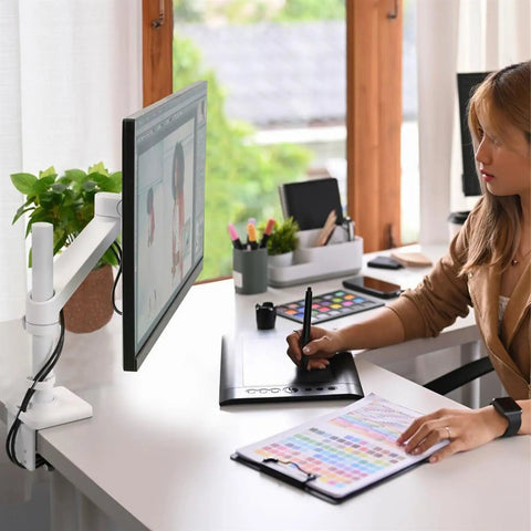 Bulletproof Monitor Arm Desktop Mount With Zero Hassle Height Adjustments And Hella Smooth Swivel Tilt Motion For Premium Ergonomic Office Setup. Woman using a monitor with desk mount.