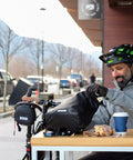Cyclist with Dayliner Mini Roll Top Handlebar Bag 3 L Waterproof Commuter Sling With Shoulder Strap And Reflective Detail Recycled Ripstop