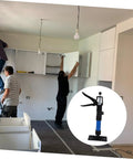 Two men installing kitchen cabinets using a Heavy Duty Telescopic Cabinet Lift Jack With Adjustable Support Pole.
