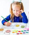 Child writing at desk with Smiley Name Tags Pack 120 Pcs Boho Pastel Smile Face Nameplates For Classroom And Office Labeling.
