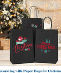 Black Kraft Paper Gift Bags With Handles 5.25 X 3.75 X 8 Inches Pack Of 20,000 for Christmas decor, front view with holiday designs