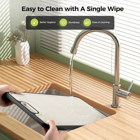 Two In One Titanium Cutting Board Heavy Duty Dual Sided Kitchen Tool being rinsed under faucet, easy to clean surface