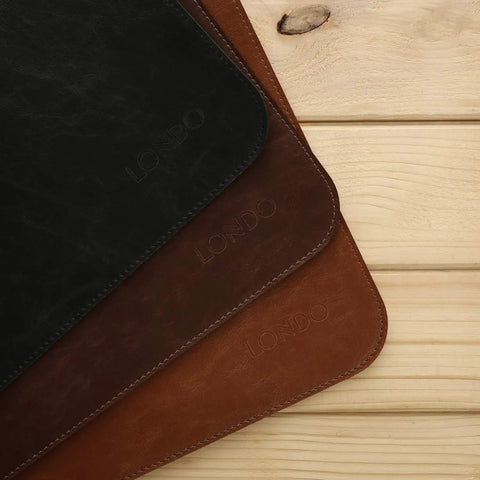 Premium Leather Extended Mouse Pad For Office And Gaming, showcasing three colors, non-slip base, close-up on wooden surface.