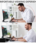 Comparison of man at desk using Dual Monitor Stand Riser For Desk Setup With 3 Shelf Adjustable Length And Tilt Extra Long Multifunctional Wood Stand Fits Computer Laptop TV Up To 43 Inches Black.