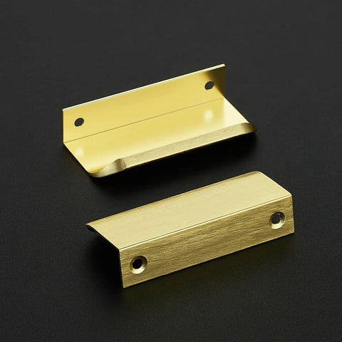 Premium Gold Cabinet Handles Finger Edge Pulls Sleek Brushed Finish two brushed gold drawer knobs on a black surface
