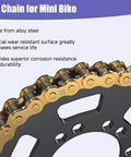 Close-up of gold alloy steel 35-chain for mini bike resting on a black sprocket.