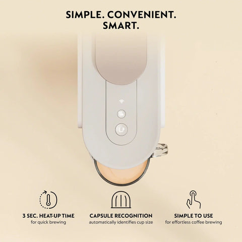 Top view of Vertuo Up All In One Coffee And Espresso Maker In White By DeLonghi with cup under spout, controls visible