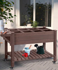 Big Ol Raised Garden Bed On Wheels With Grow Grid And Storage Shelf shown in an outdoor setting next to a plant with gardening tools.
