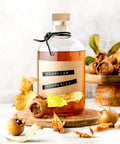 Glass bottle with a wooden cork surrounded by medlar fruit and autumn leaves, focus on 60 Pieces T Shaped Wine Corks Reusable Cork Plugs.