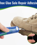 Applying Slow Dry Shoe Glue For Sole Repair Pro Grade Waterproof Clear Adhesive to brown boot sole, 60ml tube shown.