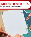 Applying Poster Strips 64 Count Damage Free Hanging Adhesive to white board on wood table, ideal for Christmas decorations
