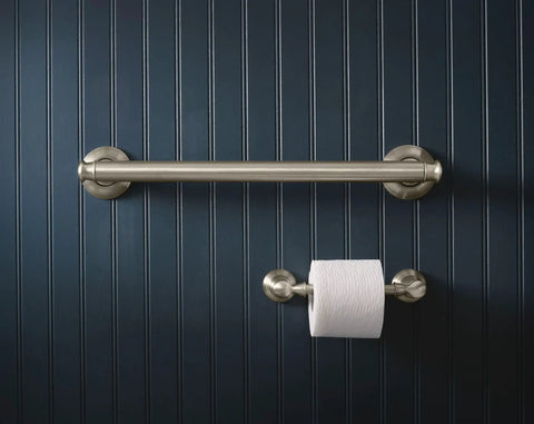 Banbury Pivoting Toilet Paper Holder in Brushed Nickel mounted on dark wall, zinc construction with spring free design, durable bathroom accessory.